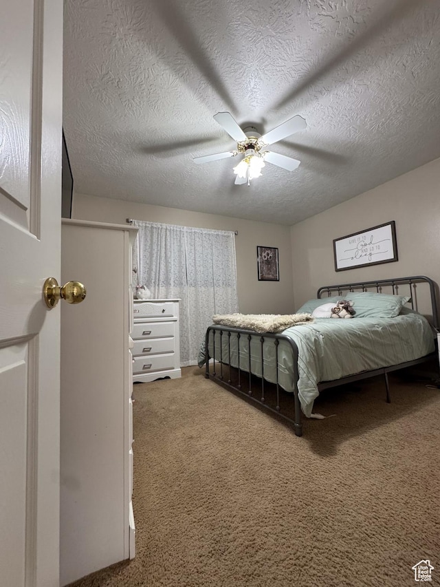 1150 W Red Hills Pkwy Unit 123, Washington, UT 84780 - carpeted bedroom with ceiling fan and a textured ceiling
