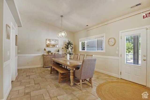 dining area with an inviting chandelier and lofted ceiling