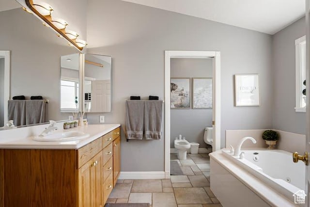 bathroom with lofted ceiling, vanity, a washtub, toilet, and a bidet
