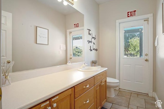 bathroom with vanity, a wealth of natural light, and toilet