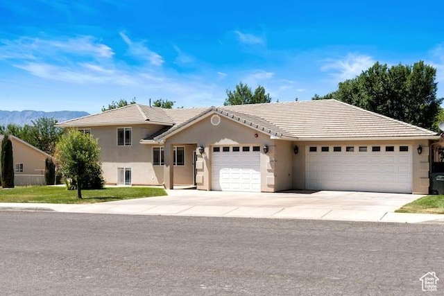 view of front of property with a garage and a mountain view