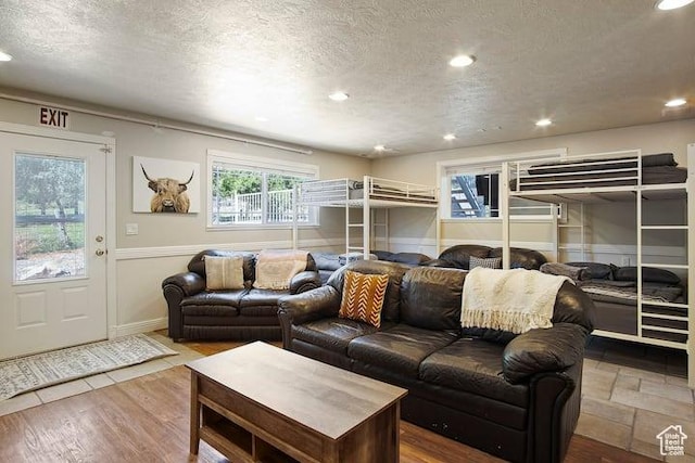 living room featuring wood-type flooring and a textured ceiling
