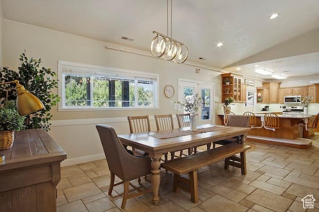 dining room with vaulted ceiling and french doors