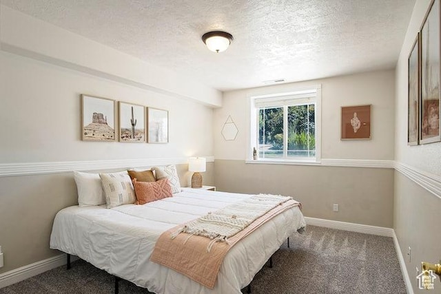 carpeted bedroom with a textured ceiling