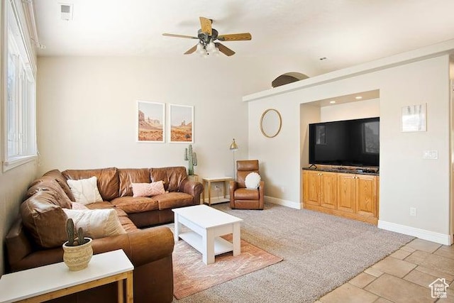 living room with lofted ceiling, light carpet, and ceiling fan