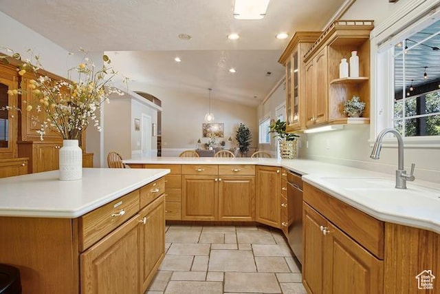 kitchen featuring lofted ceiling, a healthy amount of sunlight, kitchen peninsula, and sink