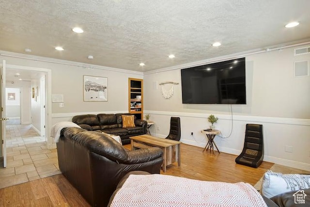 living room featuring a textured ceiling and light wood-type flooring