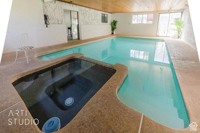 view of swimming pool with an in ground hot tub