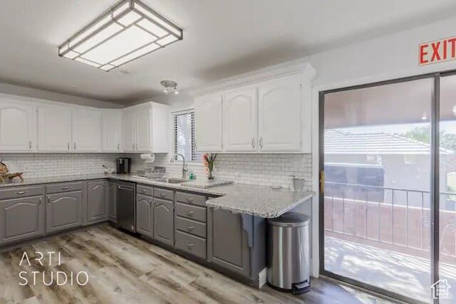 kitchen featuring sink, gray cabinets, dishwasher, light stone counters, and white cabinets