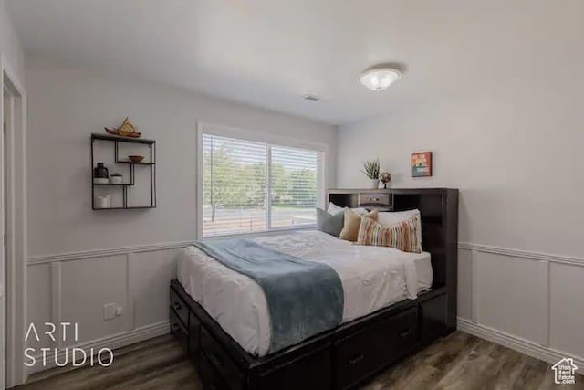 bedroom with dark hardwood / wood-style flooring