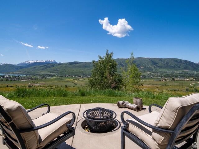 5932 E Big Horn Pkwy, Eden, UT 84310 - view of patio featuring a mountain view, a rural view, and an outdoor living space with a fire pit