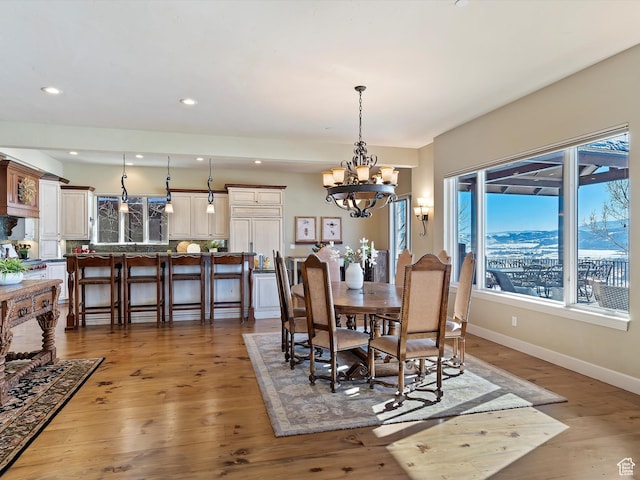 dining room with an inviting chandelier and hardwood / wood-style floors