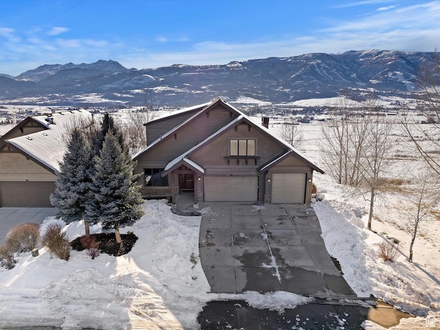 view of front of property featuring a garage and a mountain view