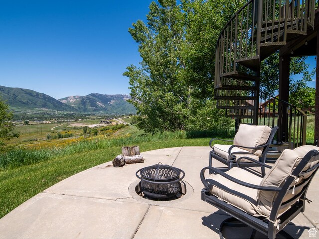 5932 E Big Horn Pkwy, Eden, UT 84310 - view of patio / terrace with stairway, an outdoor fire pit, and a mountain view