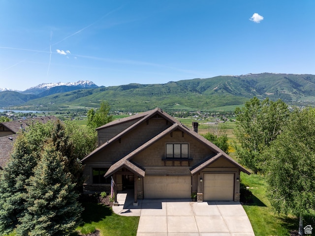 5932 E Big Horn Pkwy, Eden, UT 84310 - view of front of property featuring a mountain view, driveway, stone siding, and a garage