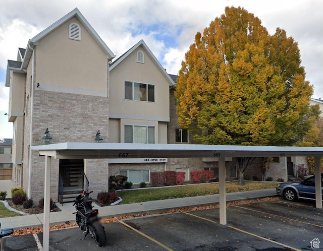 667 N 340 W, Orem, UT 84057 - rear view of house featuring uncovered parking, stucco siding, and brick siding