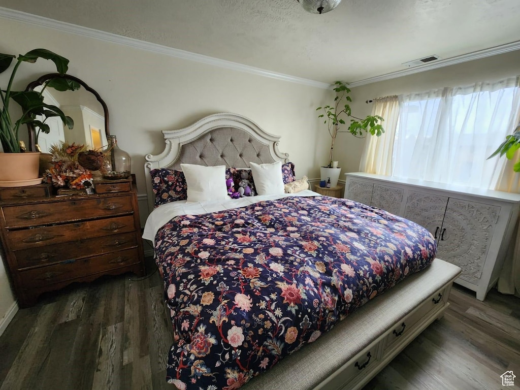 bedroom featuring dark hardwood / wood-style flooring and crown molding