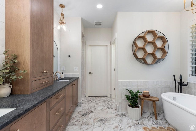 2305 E 3350 S, St George, UT 84790 - full bathroom with a sink, a freestanding tub, marble finish floor, double vanity, and recessed lighting