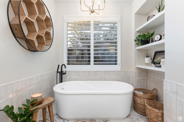 2305 E 3350 S, St George, UT 84790 - full bath with a freestanding bath, a chandelier, tile walls, and wainscoting