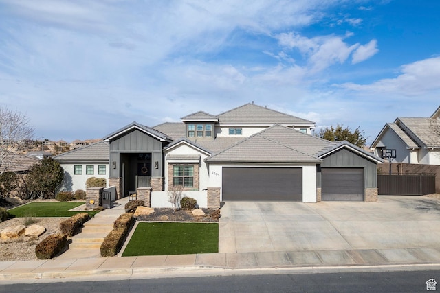 2305 E 3350 S, St George, UT 84790 - view of front of property with a front lawn, concrete driveway, a tile roof, stone siding, and a garage