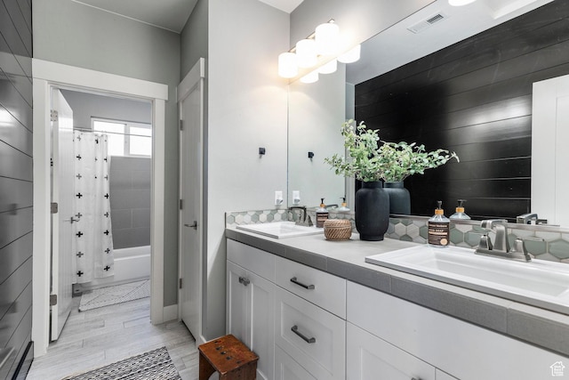 2305 E 3350 S, St George, UT 84790 - bathroom featuring double vanity, wood finished floors, visible vents, and a sink
