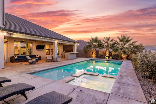 view of swimming pool featuring a fenced backyard, outdoor lounge area, ceiling fan, a pool with connected hot tub, and a patio