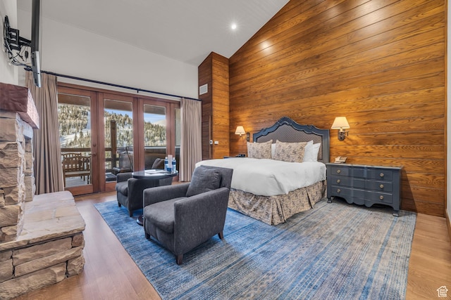 7700 Stein Way Unit 215, Park City, UT 84060 - bedroom with wood-type flooring, wooden walls, access to outside, and high vaulted ceiling