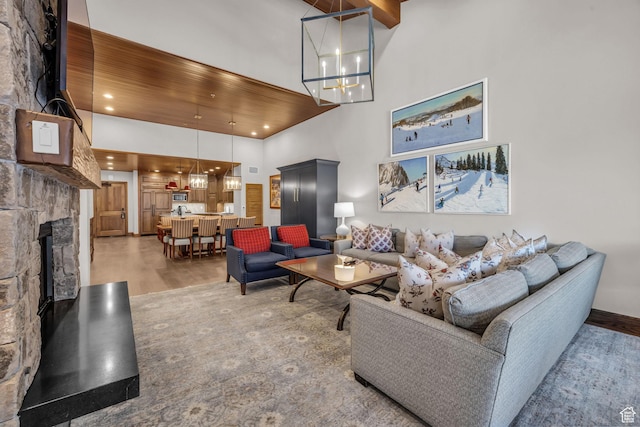 7700 Stein Way Unit 215, Park City, UT 84060 - living room featuring wood ceiling, an inviting chandelier, hardwood / wood-style floors, a high ceiling, and a fireplace