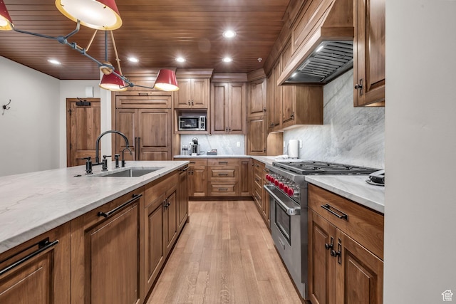 7700 Stein Way Unit 215, Park City, UT 84060 - kitchen featuring sink, light stone counters, built in appliances, custom range hood, and pendant lighting
