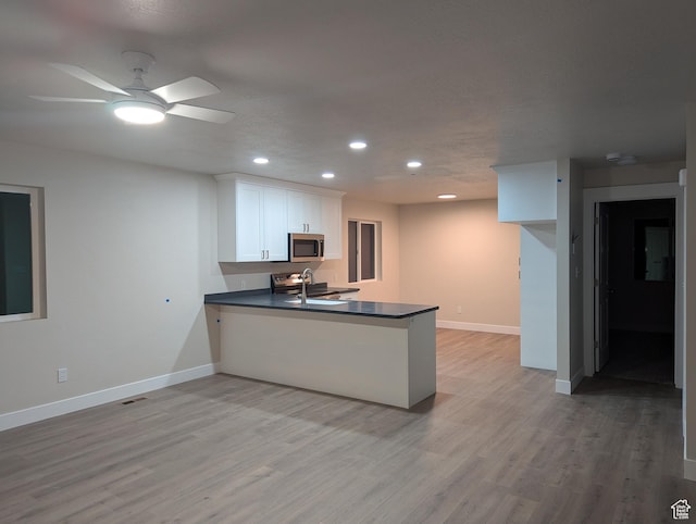 350 W Dublin S, Eureka, UT 84628 - kitchen with stainless steel microwave, baseboards, recessed lighting, a peninsula, and dark countertops
