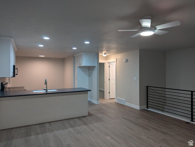 350 W Dublin S, Eureka, UT 84628 - kitchen with stainless steel range with electric cooktop, a peninsula, white cabinetry, recessed lighting, and dark countertops