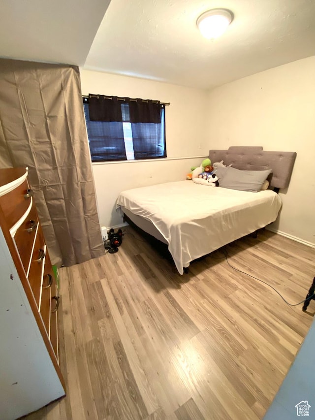 4466 W 6060 S, Salt Lake City, UT 84118 - bedroom featuring wood finished floors and baseboards