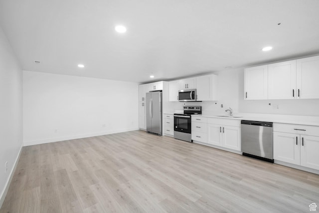 598 S Otto Ln, Grantsville, UT 84029 - kitchen with stainless steel appliances, recessed lighting, light wood-type flooring, and white cabinetry