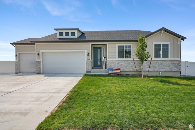 598 S Otto Ln, Grantsville, UT 84029 - view of front facade featuring board and batten siding, a front yard, stone siding, an attached garage, and driveway