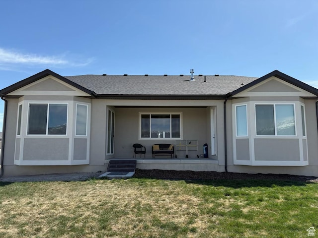 598 S Otto Ln, Grantsville, UT 84029 - rear view of house with roof with shingles, stucco siding, and a lawn