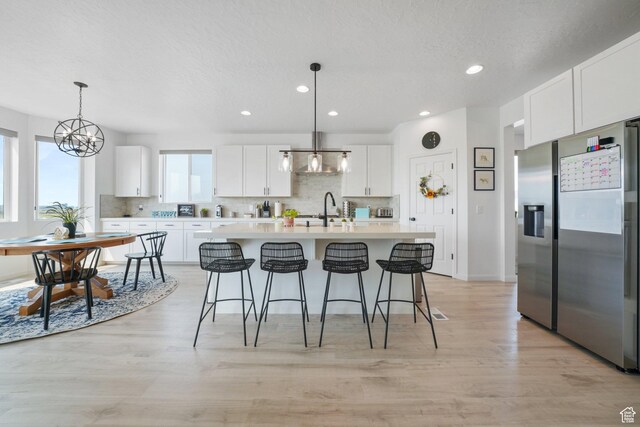 598 S Otto Ln, Grantsville, UT 84029 - kitchen featuring tasteful backsplash, stainless steel fridge with ice dispenser, light countertops, and a sink