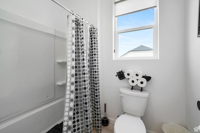 598 S Otto Ln, Grantsville, UT 84029 - bathroom featuring shower / tub combo with curtain, baseboards, and toilet