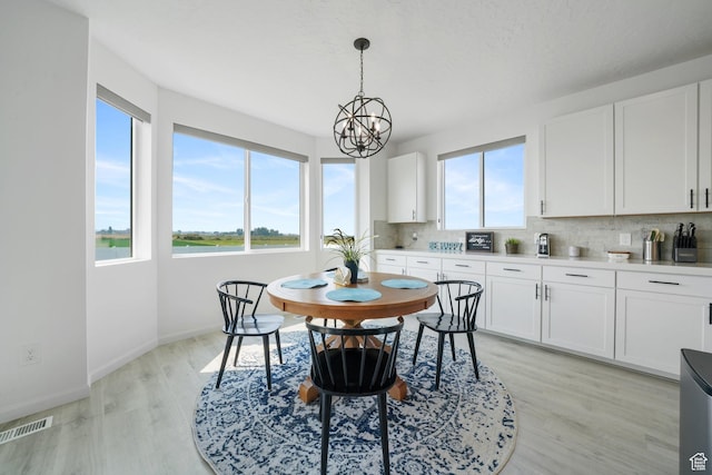 598 S Otto Ln, Grantsville, UT 84029 - dining room featuring a chandelier, light wood-type flooring, baseboards, and visible vents