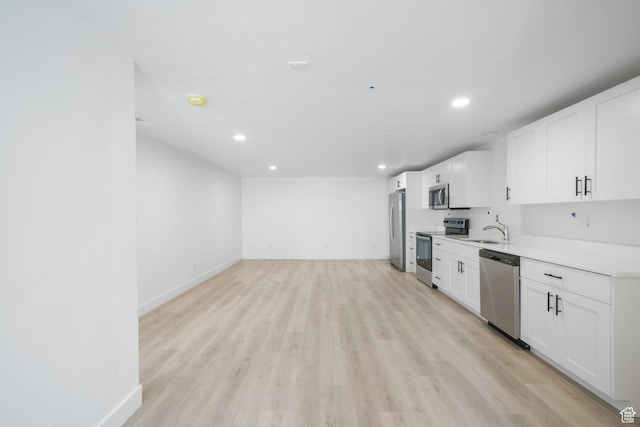 598 S Otto Ln, Grantsville, UT 84029 - kitchen with recessed lighting, light wood-type flooring, baseboards, and appliances with stainless steel finishes