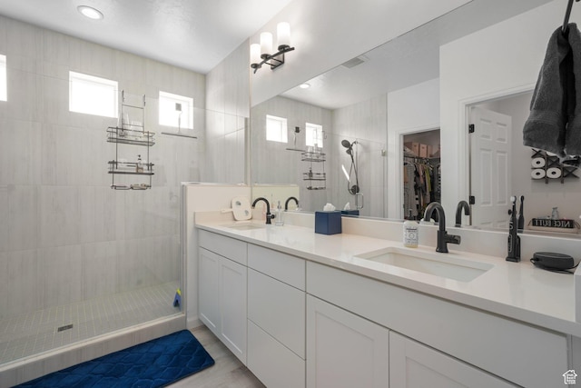 598 S Otto Ln, Grantsville, UT 84029 - bathroom with a sink, a tile shower, double vanity, and a healthy amount of sunlight