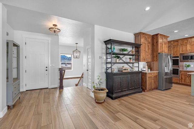 3727 S Larkspur Cir, Saratoga Springs, UT 84045 - kitchen with light wood finished floors, brown cabinets, stainless steel appliances, recessed lighting, and a notable chandelier