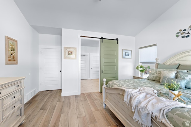 3727 S Larkspur Cir, Saratoga Springs, UT 84045 - bedroom featuring light wood finished floors, visible vents, a barn door, and vaulted ceiling