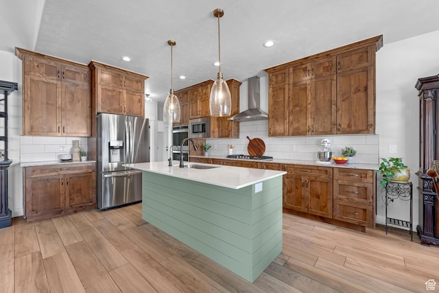 3727 S Larkspur Cir, Saratoga Springs, UT 84045 - kitchen with wall chimney range hood, a sink, light wood finished floors, and appliances with stainless steel finishes