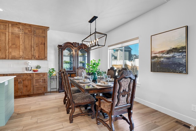 3727 S Larkspur Cir, Saratoga Springs, UT 84045 - dining space featuring a healthy amount of sunlight, an inviting chandelier, and light wood finished floors