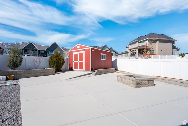 3727 S Larkspur Cir, Saratoga Springs, UT 84045 - view of patio / terrace featuring an outdoor structure, a fenced backyard, a residential view, and a storage shed