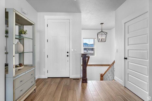 3727 S Larkspur Cir, Saratoga Springs, UT 84045 - foyer with baseboards, light wood-style flooring, and a notable chandelier