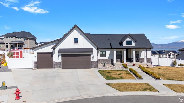 3727 S Larkspur Cir, Saratoga Springs, UT 84045 - modern farmhouse style home with stone siding, fence, concrete driveway, board and batten siding, and a mountain view