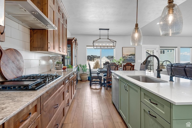 3727 S Larkspur Cir, Saratoga Springs, UT 84045 - kitchen with green cabinetry, a sink, range hood, appliances with stainless steel finishes, and light wood-type flooring