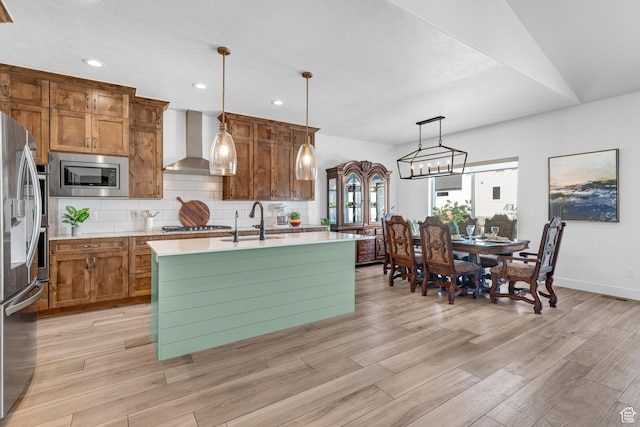 3727 S Larkspur Cir, Saratoga Springs, UT 84045 - kitchen featuring decorative backsplash, light countertops, wall chimney exhaust hood, appliances with stainless steel finishes, and a sink