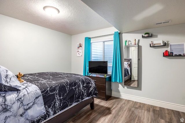 518 N 1980 E, Spanish Fork, UT 84660 - bedroom featuring a textured ceiling, baseboards, visible vents, and wood finished floors